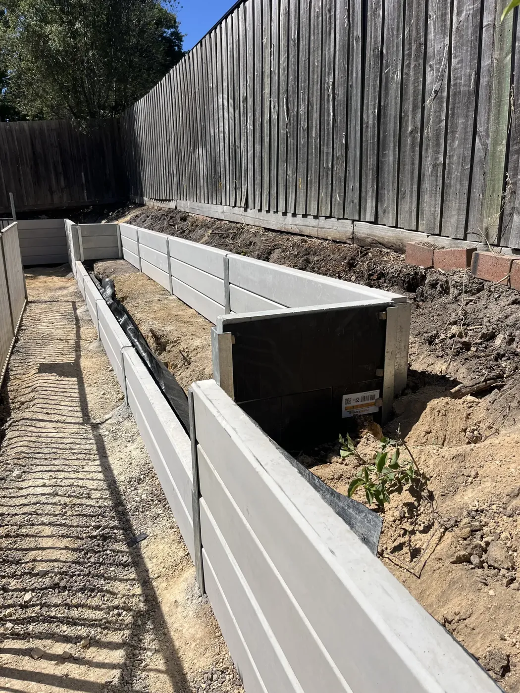 Drainage installed behind a new concrete sleeper retaining wall