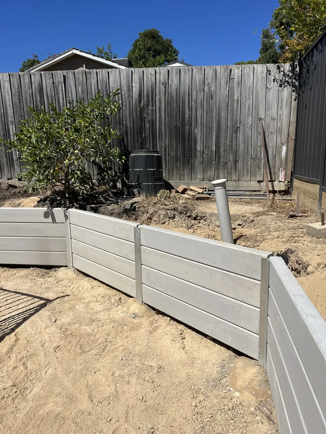 Treated pine retaining wall with a landscaped garden bed