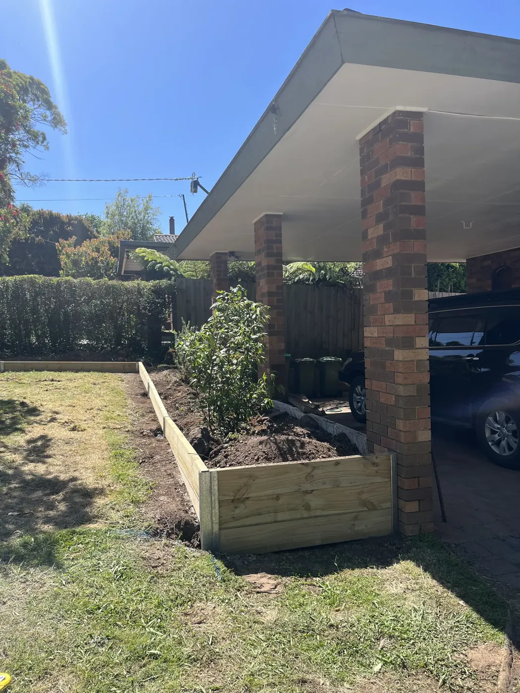Concrete sleeper retaining wall on a cut-in backyard slope
