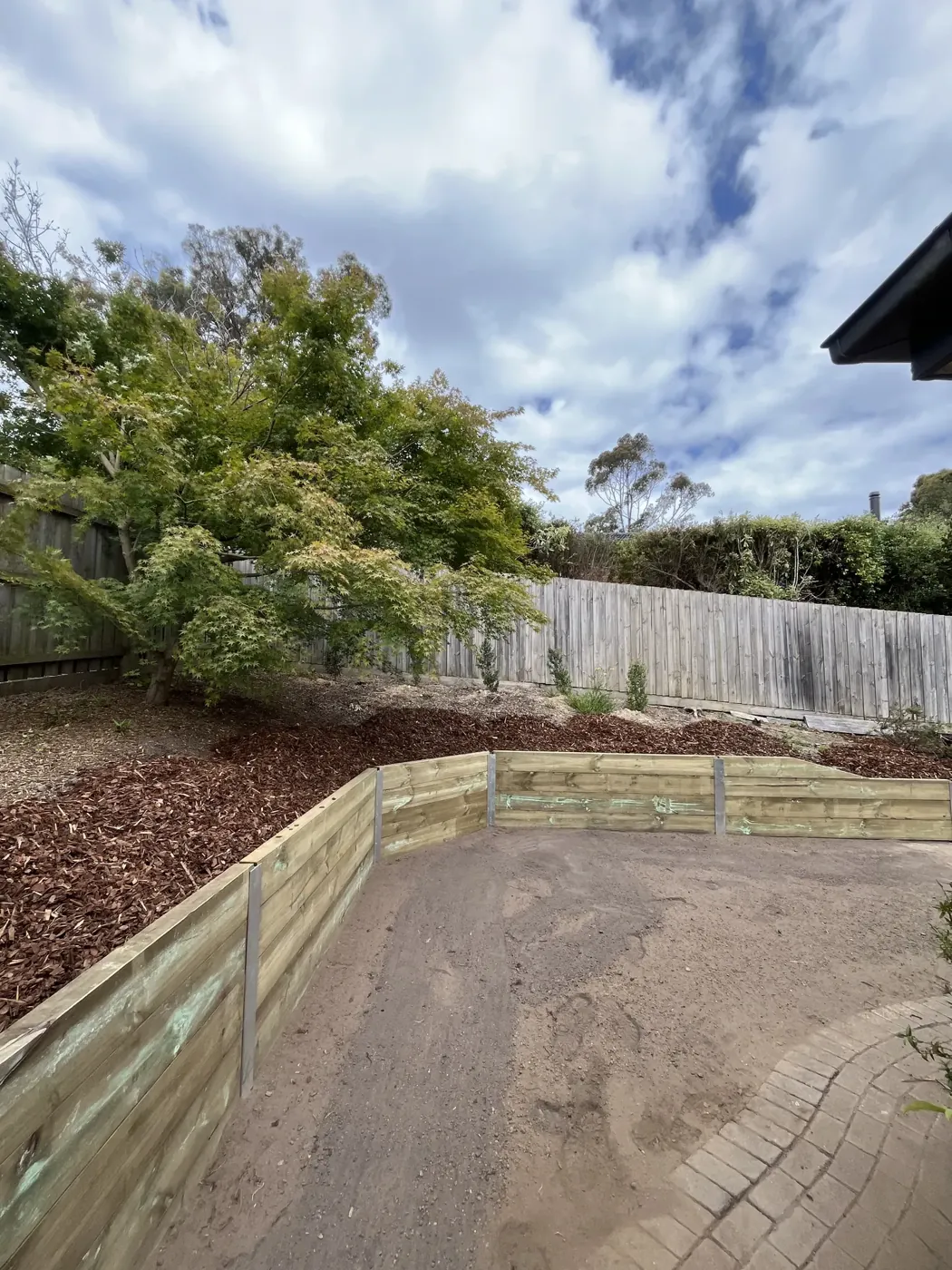 Completed concrete sleeper retaining wall with landscaped garden